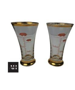 Pair of greedy pigs shot glasses with gold rims and pig illustrations