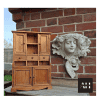 styled image of a miniture shedwork dresser made from pine with a cherub plaque on a wall backdrop