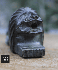 Front view of carved stone lion pyrogene showing mouth openings and striker base