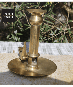 Side profile of Victorian Brass Chamberstick showing wide stable base and curved handle
